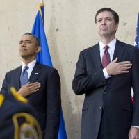 Hard landing: U.S. President Barack Obama and new FBI Director James Comey stand for the National Anthem during the latter’s inauguration ceremony at FBI headquarters in Washington on Monday FBI program's lack of safeguards allows civil liberties violations: ACLU