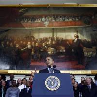 Historic stage: U.S. President Barack Obama speaks at Boston’s historic Faneuil Hall about the federal health care law on Wednesday. The venue is where former Massachusetts Republican Gov. Mitt Romney, Obama’s rival in the 2012 presidential election, signed the state’s landmark health care law in 2006, with top Democrats standing by his side Health care vow comes back to haunt Obama