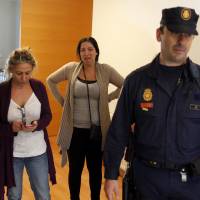 Ejected: A woman cries as police enter her apartment to evict her family from an apartment of the City Hall Housing Company in Madrid on Tuesday, as they could no longer afford to pay rent. Spanish lawmakers want to shift the country back a time zone to impose more healthy, family-oriented working hours. Long-lunching, late-working Spain mulls changing time zone