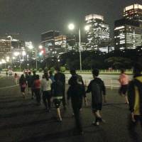 Love on the run: Men and women who are participating in a jogging matchmaking party chat as they make their way around Tokyo’s Imperial Palace in October. Find true love on the run at a jogging party