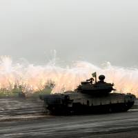 More than a war game?: The Self-Defense Forces carry out an annual live-fire drill at the Higashi Fuji range in Gotemba, Shizuoka Prefecture, on Aug. 25. Pacific gateway isles get SDF surface-to-ship missiles in drill
