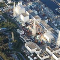 Out of commission: This aerial view shows Tokyo Electric Power Co.’s Fukushima No. 1 nuclear plant in September. Experts commissioned by nuclear watchdog fail to report ¥40 million in funding