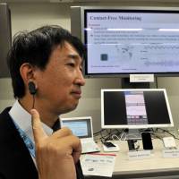 Driving aids: Yasuhiko Nakano, a research manager of Media Processing Systems Laboratories at Fujitsu Laboratories Ltd., shows a drowsiness detection sensor. Fujitsu labs in touch, ahead of the curve on the tech road