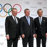First visit as boss: IOC president Thomas Bach (center) stands with JOC president Tsunekazu Takeda and IOC vice president John Coates at a news conference in Tokyo on Wednesday. IOC chief Bach leaves door open for baseball at 2020 Games