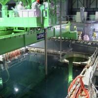 Out of their depth?: Workers at the Fukushima No. 1 nuclear plant remove fuel rods from a pool in the reactor 4 building, in a handout picture provided by Tokyo Electric Power Co. on Monday Fukushima job feared too perilous for Tepco