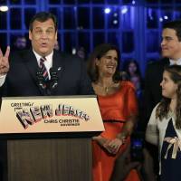 Count ’em: Republican New Jersey Gov. Chris Christie holds up two fingers to signal his second term after his election victory in Asbury Park on Tuesday. With him on stage are his wife, Mary Pat Christie, and their children, Andrew and Bridget For divided GOP, election proves no end to debate