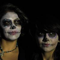 Paying homage: Women with their faces painted as a traditional Mexican “Catrina” pose during Day of the Dead celebrations at National Autonomous University in Mexico City on Wednesday. The Catrina skeleton figure, wearing an elegant broad-brimmed hat, was first done as a satirical engraving by artist Jose Guadalupe Posada in the early 19th century Mexican Day of Dead 'Skeleton Lady' spreads look