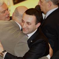 Georgian Prime Minister Irakli Garibashvili (center) is congratulated after being approved as prime minister in the parliament in Kutaisi, 250 km west of Tbilisi, on Wednesday. Georgia's Garibashvili becomes Europe's youngest government chief
