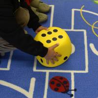 Rolling the dice: A preschool child plays on a carpet at a kindergarten in Eichenau, near Munich, on Oct. 9 When age 6 is still too early: German parents delay kids' school entrance