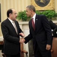 Weapons push: U.S. President Barack Obama shakes hands with Iraqi Prime Minister Nouri al-Maliki on Friday, following their meeting in the Oval Office of the White House in Washington Obama meets Iraq's al-Maliki, remains mum on arms sales