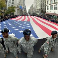 Forget the 50 states: Members of the New York State National Guard carry a large flag during the annual Veterans Day Parade on Monday on Fifth Avenue in New York City. An author says the U.S is really made up of 11 distinct “nations.” Author divides U.S. into 11 American nations