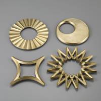 Masanori Oji’s brass trivets (2009) — “Tsuki (moon),” “Taiyo (sun),” “Ginga (galaxy),” “Hoshi (star)” Old ways to break the mold of mass production