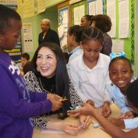 Outreach: Ikumi Yoshimatsu, Miss International 2012, shows third-graders at Public School 307 in Brooklyn, New York, how to fold origami frogs Jan. 24. Miss International finds link with U.S. students