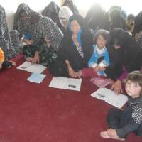 Fundamentals: Afghan women, including mothers with children, participate in a reading class organized by NICCO as part of the group’s support program to build self-reliance. NICCO driven to continue Afghan aid