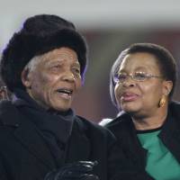 Third time lucky: Former President Nelson Mandela and his third wife, Graca Machel, arrive for the 2010 World Cup match between the Netherlands and Spain on July 11, 2010, in Soweto, suburban Johannesburg. Mandela endured family tragedies in private life