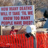 No permit: Paul Libera sits with a sign he raised in his yard in Webster, New York, on Jan. 17, a few weeks after a gunman shot and killed two firefighters in the town and after the Dec. 14, 2012, massacre at Sandy Hook Elementary School in Newtown, Connecticut. Gun rift widens, year after Newtown