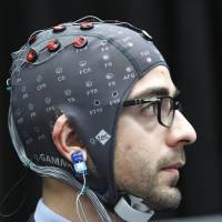 Make a wish: A man sends brain-computer interface commands in this file photo. The global advertising and marketing company JWT predicts that brain-computer interfaces, or BCIs, will push further into the commercial mainstream next year. 2013 was an amazing year in tech