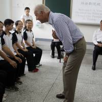 Old school: U.S. Vice President Joe Biden talks to students as Chinese Vice President Xi Jinping (second from right) watches during their August 2011 visit to Qingchengshan High School in Dujiangyan, in southwestern China’s Sichuan province. Biden set to meet Xi as U.S.-China ties are tested amid ADIZ dispute