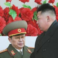 Booted: North Korean ruler Kim Jong Un (right) attends a military parade in Pyongyang with uncle Jang Song Thaek in February 2012. State media confirmed Monday that Jang, vice chairman of the country’s top body and once seen as the power behind the throne, had been stripped of all official titles and membership in the ruling party for crimes including corruption, womanizing and factionalism. Purge of Kim uncle sends chilling message to North Korea's elite