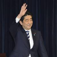 Home ground: Prime Minister Shinzo Abe waves to his constituents Saturday during a meeting in Shimonoseki, Yamaguchi Prefecture. Abe steps on Washington's toes