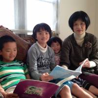 All in the family: Taichi (left), Mayu and Fuyu Sasada sit in their living room in December with their mother, Maho. Immersion tactics come with risks and benefits