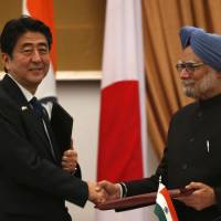 HeadlineKey partners: Prime Minister Shinzo Abe and Indian Prime Minister Manmohan Singh shake hands as they exchange signed agreements during a meeting in New Delhi on Saturday. Defense cooperation ties with India bolstered