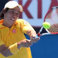 Wins in five: Kei Nishikori plays a shot from Marinko Matosevic in their first-round match at the Australian Open on Tuesday. Nishikori outlasts Matosevic
