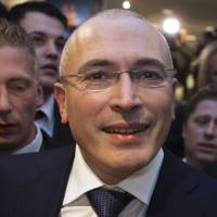 On the move: Former Russian oil tycoon and Kremlin critic Mikhail Khodorkovsky leaves the Wall Museum at Checkpoint Charlie in Berlin after a Dec. 22 news conference. On Sunday Khodorkovsky arrived in Switzerland. Khodorkovsky to campaign for release of political prisoners in Russia