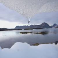 On thin ice: An iceberg melts in Kulusuk, Greenland, near the Arctic Circle, in August 2005. Over the next 30 years climate change is likely to open up a major polar shipping route between the Pacific and Atlantic. Melting Arctic ice brings hope to Russian city