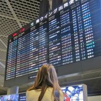 Back to school — by airplane: A teenager heads back to school last week after a trip back home to Japan. For students attending high schools overseas, the departure lounge is a familiar sight. Parents of mixed kids look abroad for high schools
