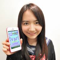 Rika Shiiki shows off a smartphone app she helped create that works like an alarm clock. 'Generation Resignation' youngsters defy stereotypes