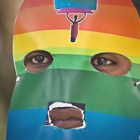 A Kenyan gay rights activist wears a mask to preserve his anonymity at a rare protest against neighboring Uganda’s increasingly tough stance against homosexuality and in solidarity with members of its LGBT community, outside the Uganda High Commission in Nairobi on Feb. 10. Ugandan President Yoweri Museveni has said he will sign an anti-homosexuality bill into law “to protect Ugandans from social deviants.” West's efforts to shield gays fail in Africa