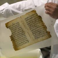 Shreds and tatters: An employee works on a restoration of an old manuscript at the al-Aqsa mosque compound library in Jerusalem. Old manuscripts get face-lift at Jerusalem mosque
