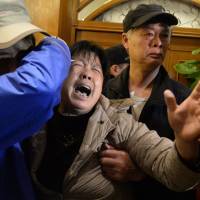 A relative of passengers on Malaysia Airlines flight MH370 cries after hearing the news at a hotel in Beijing on Monday that the plane plunged into Indian Ocean. Flight MH370 crashed in Indian Ocean: Malaysia