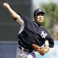 Impressive: New York’s Masahiro Tanaka fires a pitch against Philadelphia in the fifth inning of a spring training game on Saturday. Tanaka looks sharp in debut