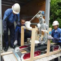 Quince, a robot developed by a group led by Chiba Institute of Technology, is loaded on a truck for delivery to the crippled Fukushima No. 1 nuclear plant in June 2011. Robots make progress in probing leaky reactors