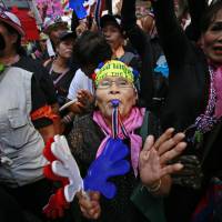Anti-government supporters rally in support of peaceful protests during a memorial for the children killed in recent bomb blasts in Bangkok on Wednesday. People power catches U.S., allies off guard