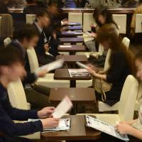 People hoping to find love converse during a matchmaking party hosted by Exeo in Tokyo on Sunday. Abe funds matchmaking to ease welfare bill