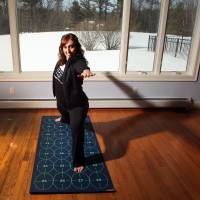 Healthy digits: Elizabeth Morrow demonstrates her Yoga by Numbers mat. Yoga by Numbers adds up to poses to everyone