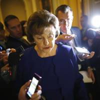 U.S. Sen. Dianne Feinstein is trailed by reporters as she walks to the weekly Democratic caucus policy luncheon at the U.S. Capitol in Washington on Tuesday. A dispute between the CIA and a U.S. Senate committee that oversees it burst into the open earlier the same day when Feinstein accused the agency of spying on Congress and possibly breaking the law. Senator accuses CIA of meddling in torture probe
