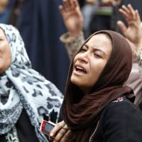 Relatives and families of members of the Muslim Brotherhood and supporters of ousted President Mohamed Mursi react Monday in front of the court in Minya, Egypt, after hearing the sentence handed to Muslim Brotherhood leader Mohamed Badie and other Brotherhood supporters. Muslim Brotherhood chief Mohamed Badie, 682 supporters get death rap