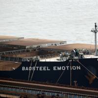 The Baosteel Emotion, a 226,434-ton ore carrier operated by Mitsui O.S.K. Lines, is seen docked at the port of Maji Island, south of Shanghai, on Tuesday. A Chinese maritime court in Shanghai seized the ship Saturday in a move Tokyo warned could have an adverse impact on Japanese businesses in China. China holding three workers, Marubeni says