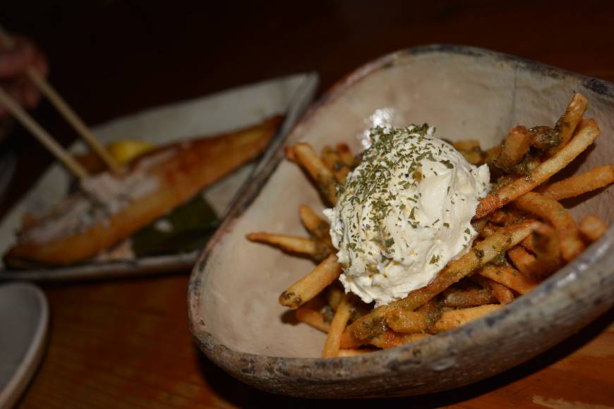 Gohanya Isshin Eat more chips: Fries are not the only dish at Gohanya Isshin, but they certainly are to die for, coated with pesto and topped with cream cheese. | JJ O'DONOGHUE