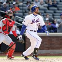 Walk it off: The Mets’ Ike Davis (right) and Reds catcher Tucker Barnhart watch Davis’ ninth-inning grand slam on Saturday. Davis lifts Mets to win with ninth-inning grand slam