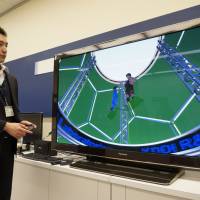 Hiroshi Sanko, a research engineer at KDDI R&D’s Ultra-Realistic Communications Laboratory, demonstrates a video made with free-viewpoint imaging technology to show digitally replicated viewpoints at the lab in Fujimino, Saitama Prefecture, on March 25. KDDI sending futuristic technologies to a screen near you