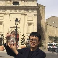 Beijing artist Liang Kegang collects fresh air in Provence, France, on March 29. The jar of air, a piece of conceptual art to protest his native city's choking pollution, has fetched $860 in a small auction. Beijing artist auctions jar of fresh Provencal air for $860 in smog-ridden China