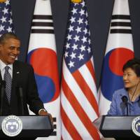 U.S. President Barack Obama listens to questions from reporters as South Korean President Park Geun-hye watches during a joint news conference after their meeting at the presidential Blue House in Seoul on Friday. Obama warns of tougher sanctions if North tests nuclear device