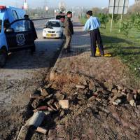 Pakistani policemen inspect the site of a bomb explosion in Islamabad on Thursday. Pakistan's former military ruler Pervez Musharraf, who is on trial for treason, escaped the bomb blast in the early hours, police said. Pakistan's Musharraf survives apparent assassination attempt