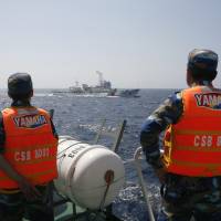 Vietnamese personnel monitor a Chinese Coast Guard vessel in the South China Sea on May 15. U.S. backs bolstered military role