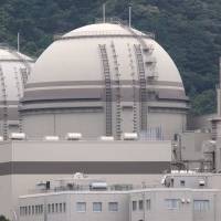 Reactors 4 and 3 stand idle at Kansai Electric Power Co.’s Oi nuclear plant in Fukui Prefecture in June 2012, a month before they became the first units in the country to be restarted after the Fukushima crisis. Kepco could defy courts and restart Oi reactors despite legal block